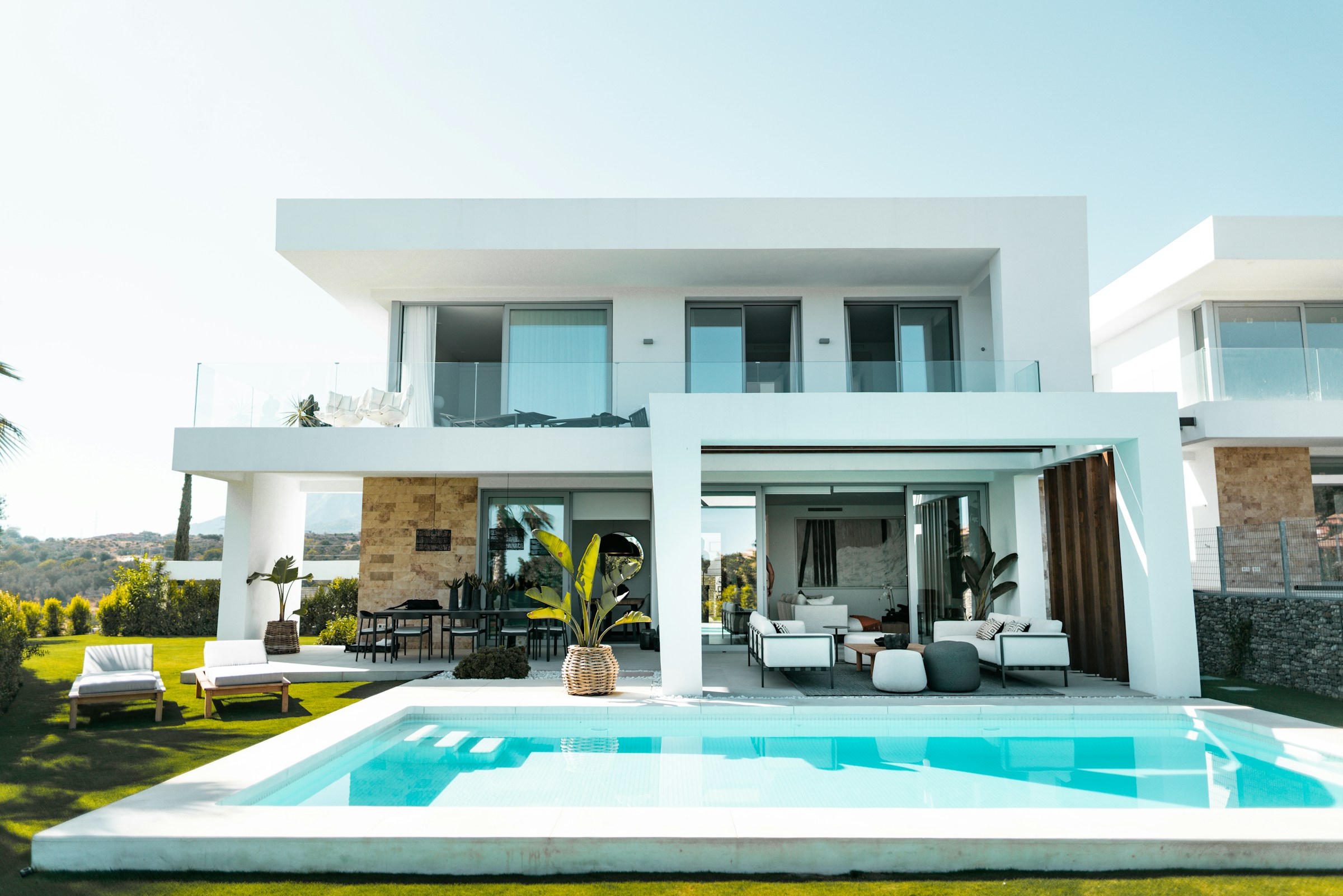 A modern luxury house with a pool at dusk